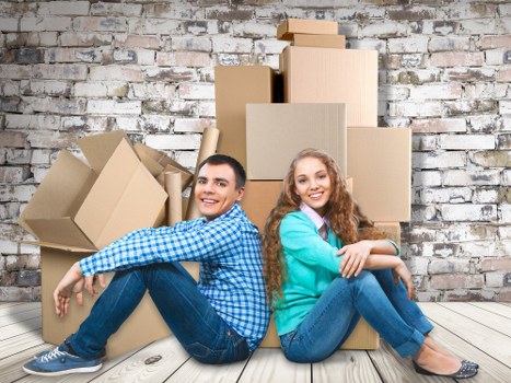 Professional movers loading boxes and furniture for urgent relocation