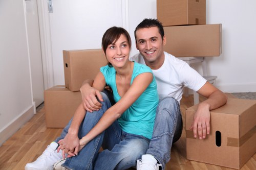 Movers carrying boxed belongings during a Battersea flat removal